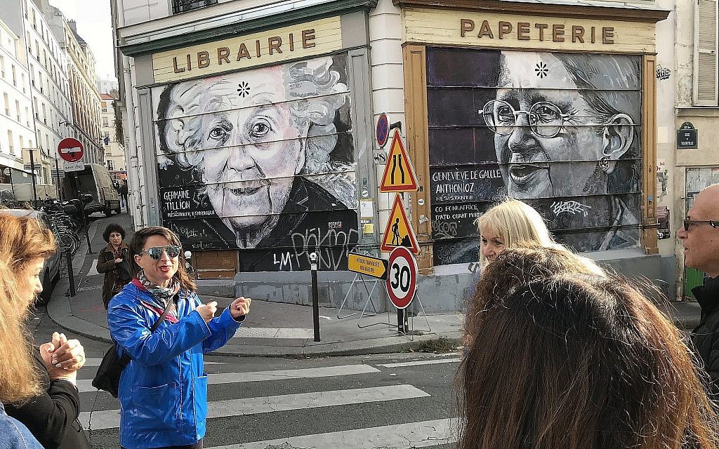 Shiry Avny explains on a tour how street artists apply their work on many different surfaces. (Robert Sarner/ Times of Israel)