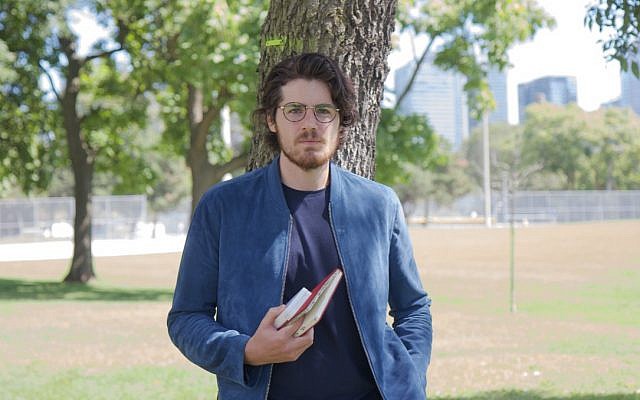 Film director Daniel Roher takes a break from putting the finishing touches on his new documentary, ‘Once Were Brothers,’ in a Toronto, Ontario park on August 29, 2019. (Etye Sarner)