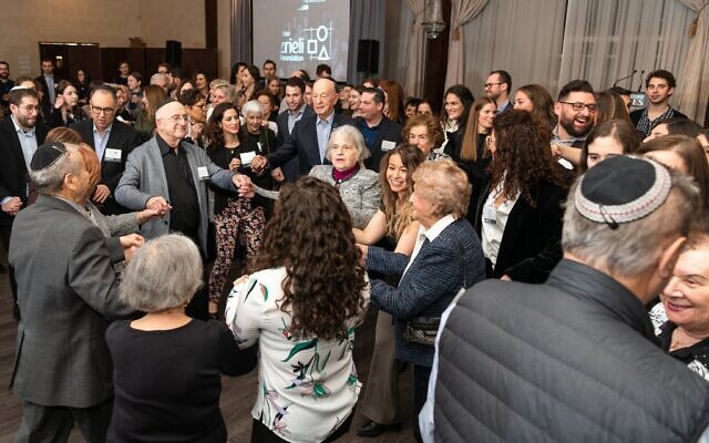 Holocaust survivors join with attendees to dance the hora at the Dinner of Miracles in Toronto, December 15, 2019. (Liora Kogan)