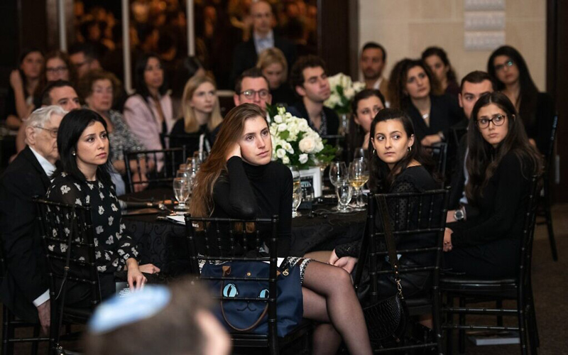 Attendees watch a presentation at the Dinner of Miracles in Toronto, December 15, 2019. (Liora Kogan)