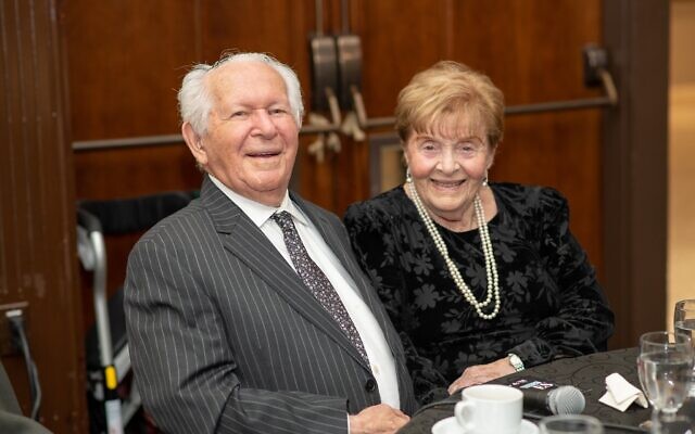 Holocaust survivors Howard and Nancy Kleinberg, who met at Bergen-Belsen and then reunited in Canada two years later and got married, speak at their table at the Dinner of Miracles in Toronto, December 15, 2019.