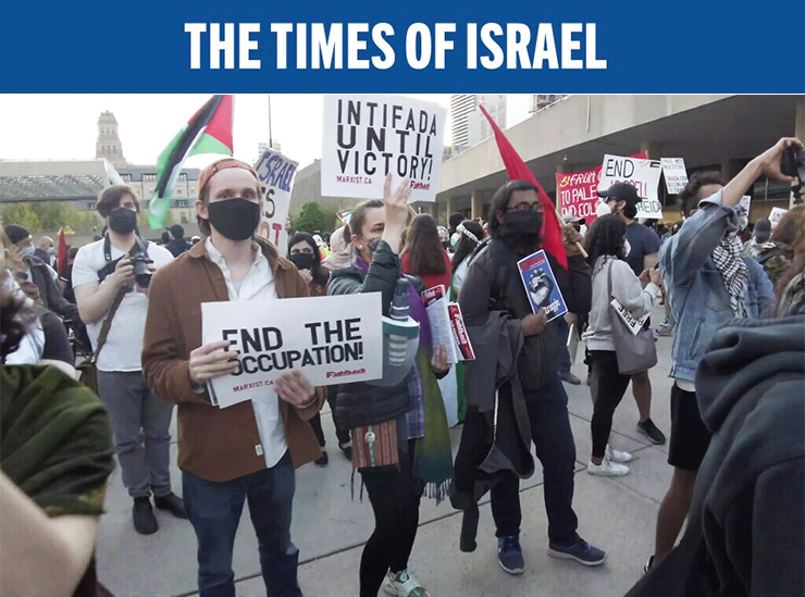 A woman holds a sign that says 'Intifada until victory' at a pro-Palestinian rally held during Israel's Operation Guardian of the Walls, in Nathan Phillips Square, downtown Toronto, May 15, 2021. (Screenshot YouTube)