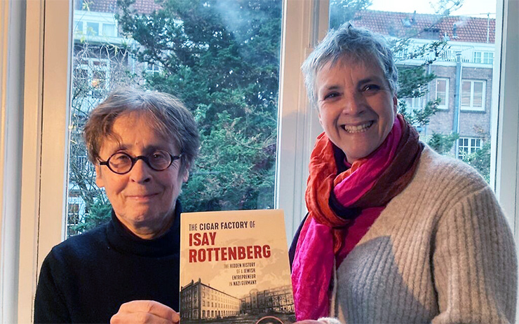 Dutch co-authors of ‘The Cigar Factory of Isay Rottenberg’ and distant cousins of Michael Levine, Hella Rottenberg, left, and Sandra Rottenberg hold the English-language edition of their book in December 2021.