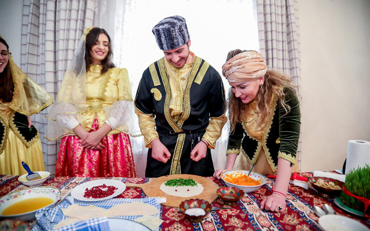 George Deek and his wife Anna, pictured at right, learn to cook traditional Azerbaijani food during the holiday of Novruz, in Baku, March 2021.