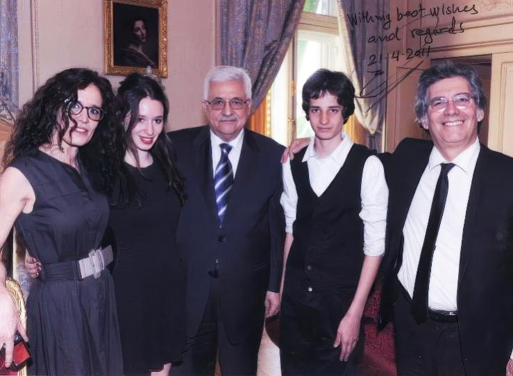 Ofer Bronchtein, right, with his family and Palestinian Authority President Mahmoud Abba, center, in Paris on April 21, 2011, when Abbas presented Bronchstein with a Palestinian passport. (Courtesy)