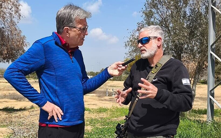 Pat Johnson interviews Harel Oren, who helped defend Kibbutz Re’im from invading Hamas terrorists on October 7, at Kibbutz Re’im, March 2025. (Courtesy/ Dotan Ninveh)