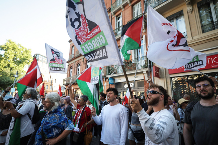 Protestors chant and wave flags as they demonstrate in support of convicted Lebanese terrorist Georges Abdallah ahead of the Paris Court of Appeal’s decision on his release, in Toulouse, southwestern France, on July 14, 2025.